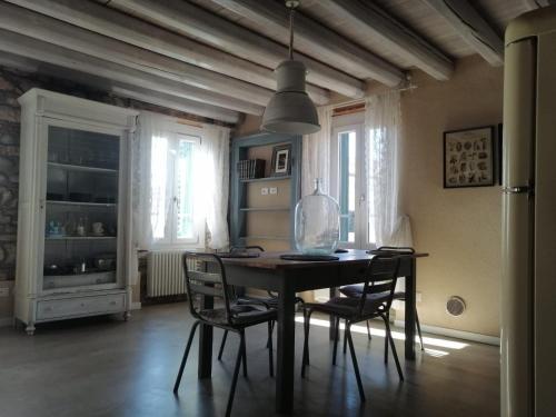 a dining room with a table and chairs at Saxa Apartment in Verona