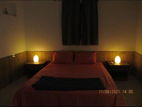 a bedroom with a large bed with two lights on it at Luna House Asala Beach in Dahab