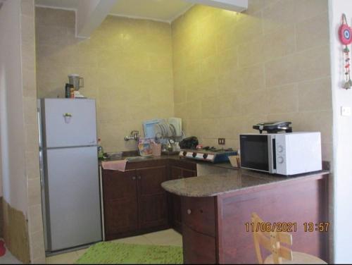 a kitchen with a white refrigerator and a counter at Luna House Asala Beach in Dahab