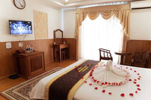 a bedroom with a bed with red roses on it at Window 1 Hotel in Kon Tum