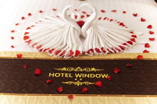 a cake with two white swans on top of it at Window 1 Hotel in Kon Tum
