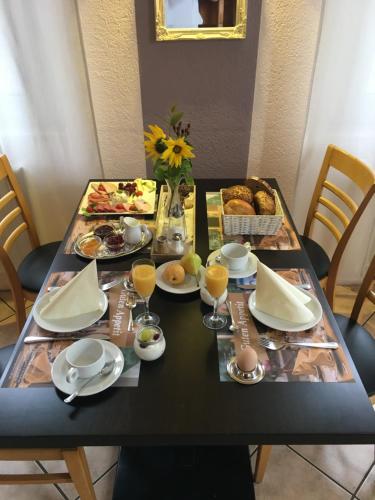 a table with breakfast foods and drinks on it at Hotel-Restaurant zur Post in Wabern