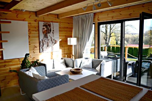 a living room with a couch and a table at Domki Pod Cerkwią in Komańcza