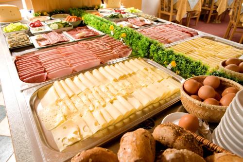 a buffet of cheese and meats and eggs on a table at Pension Gabriele in Unterlamm