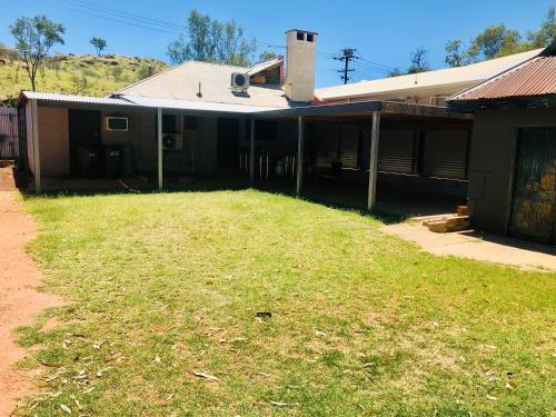 an empty yard in front of a house at Entire 4 Bedroom pets friendly home in Alice Springs CBD with 2 kitchens 2 bathrooms Toilets and plenty of free secured parking in Alice Springs