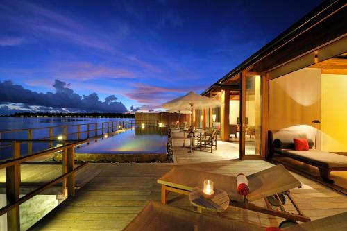 a resort balcony with a view of the water at Villa Nautica Paradise Island Resort in North Male Atoll