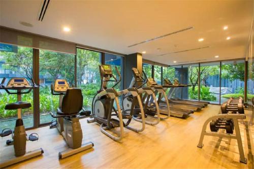 a gym with several treadmills and elliptical machines at The Deck patong Luxury Apartments The Deck patong in Patong Beach