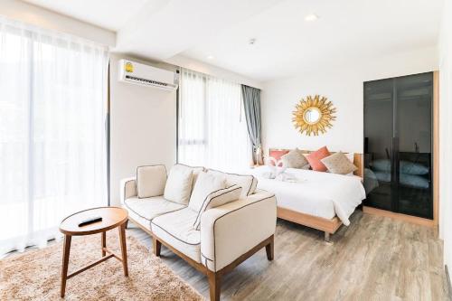 a living room with a couch and a bed at The Deck patong Luxury Apartments The Deck patong in Patong Beach