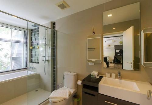 a bathroom with a toilet and a sink and a shower at The Deck patong Luxury Apartments The Deck patong in Patong Beach