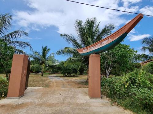 a large boat sign on a dirt road at Yala Peace Cottages in Tissamaharama