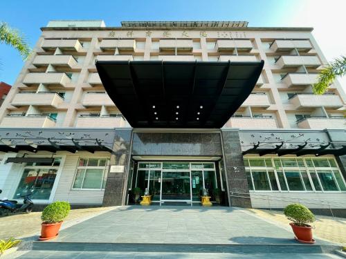 a large building with the front entrance to it at Sendale Tainan Science Park Hotel in Xinshi