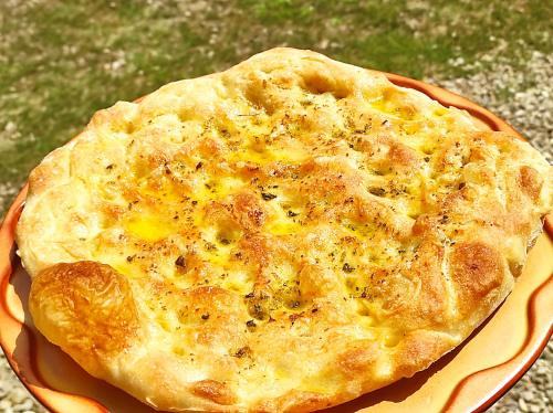a pizza sitting on top of an orange plate at Podere Casanova in Montespertoli