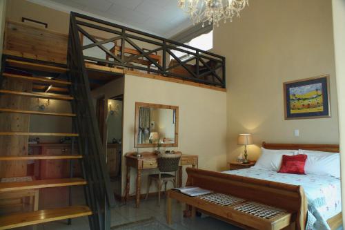a bedroom with a bunk bed and a desk at 75 on Milner Lodge in Kimberley