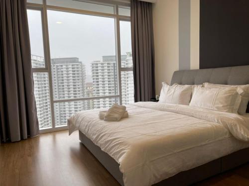 a bedroom with a large bed and a large window at KL East The Ridge in Kuala Lumpur