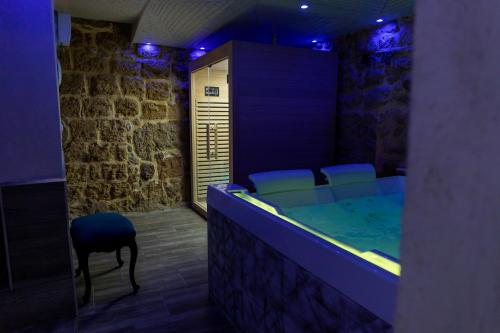 a room with a hot tub with chairs in it at Caveau in Palermo