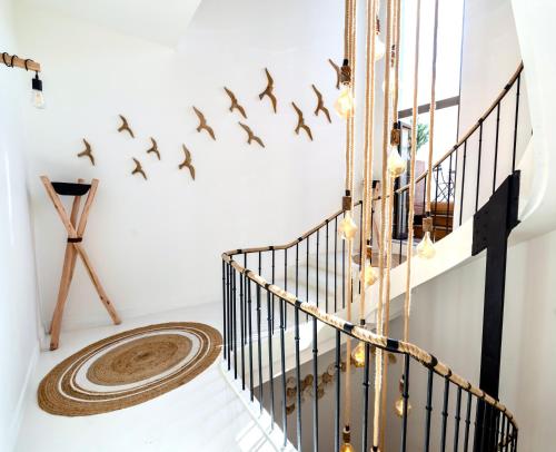 a group of birds flying over a staircase in a house at Le S in Argelès-sur-Mer