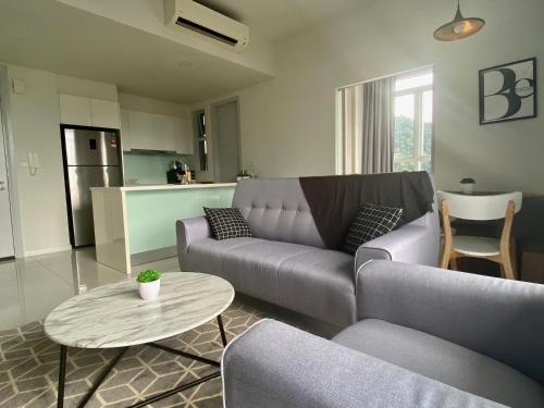 a living room with a couch and a table at KL East The Ridge in Kuala Lumpur