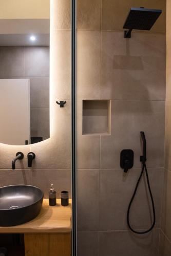 a bathroom with a sink and a shower at Syvota Apartments Cozy in Syvota