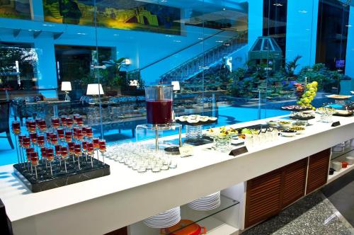 a counter with a display of food and drinks at Radha Regent, Chennai in Chennai