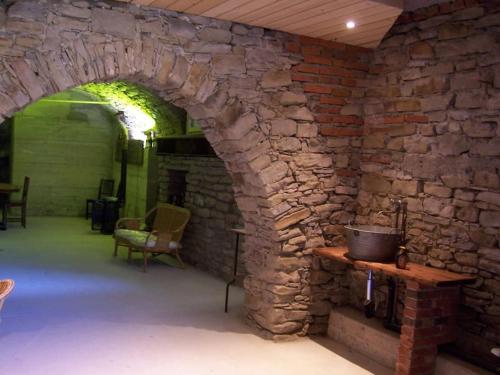 a room with a stone wall and a brick oven at Orbregno Country Houses with Personal Wine Cellar in Prasco