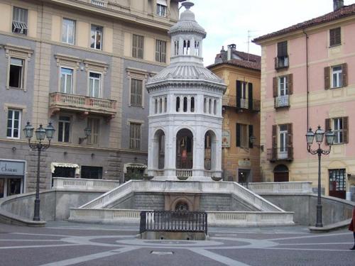 a white tower in the middle of a building at Orbregno Country Houses with Personal Wine Cellar in Prasco