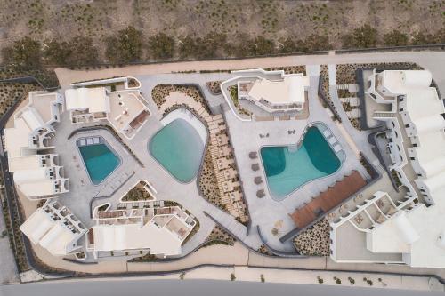 an aerial view of a resort with two swimming pools at Orama Hotel & Spa in Fira