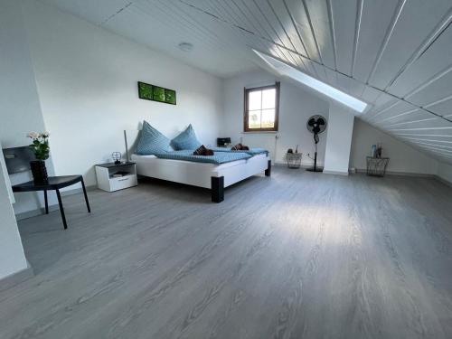 a large white room with a bed and a table at Brulaire Büsingen am Hochrhein in Busingen am Hochrhein
