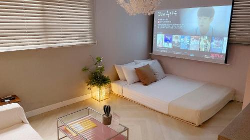 a living room with a couch and a tv at Hostel Mihojae Seomyeon in Busan