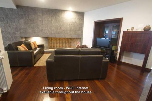 a living room with a couch and a fireplace at 2Stay - Luxury in Ponta Delgada