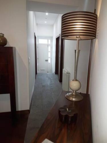 a hallway with a lamp on a wooden table at 2Stay - Luxury in Ponta Delgada