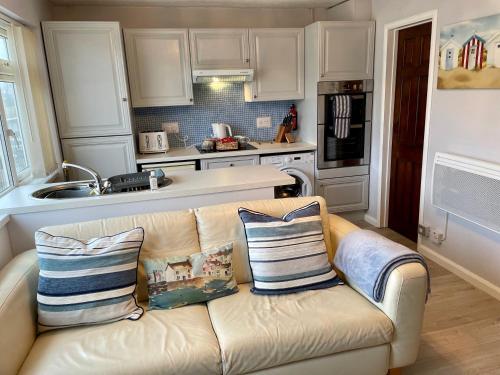 a living room with a couch in a kitchen at Apartment 18 Hill View in Brean