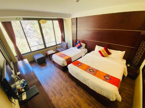Ένα ή περισσότερα κρεβάτια σε δωμάτιο στο Sapa Vista Hotel