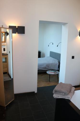 a room with a bedroom with a bed and a mirror at Peter House in Nivelles