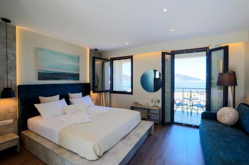 a bedroom with a large white bed and a couch at SAMI BEACHVIEW in Sami