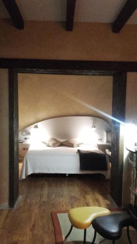 a bedroom with a large bed with a white bedvisor at Posada Real de Las Misas in Puebla de Sanabria