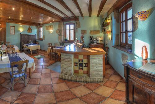 a large room with a kitchen and a bar in it at Hotel Boutique Bodegas De Arnes - Adults Only in Graus