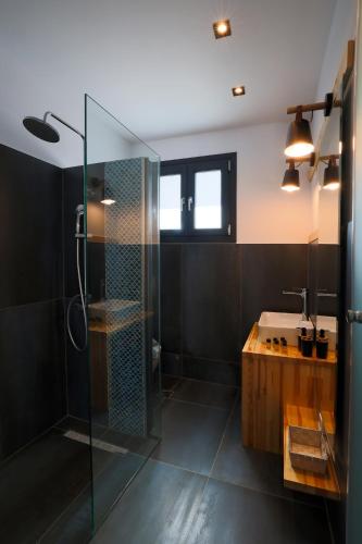 a bathroom with a glass shower and a sink at SAMI BEACHVIEW in Sami