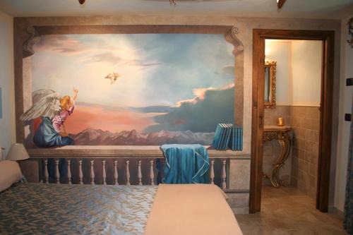 a bedroom with a painting on the wall at Le Petit Coin De Maison Chante Lune in Introd
