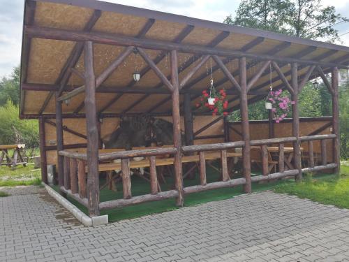 a barn with cows inside of it at Hanul cu Noroc in Moieciu de Jos