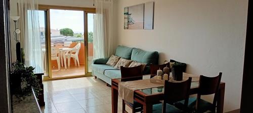 - un salon avec un canapé bleu et une table dans l'établissement Cambrils Vista Mar, à Cambrils