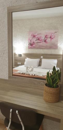 a reflection of a bed in a mirror at Paradise Hotel in Samos