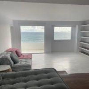 a living room with a couch and a view of the ocean at Boathouse in Kardamaina