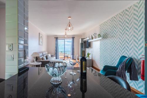 a living room with a table with wine glasses on it at Calandiva in Caniço