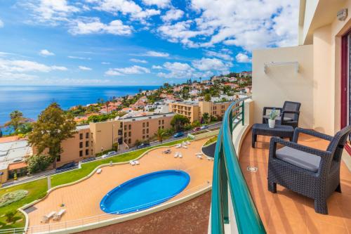 a balcony with a view of the ocean at Calandiva in Caniço