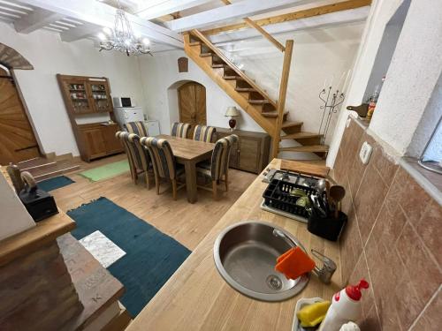 a kitchen and dining room with a sink and a table at Borospince Vendégház in Pécsely