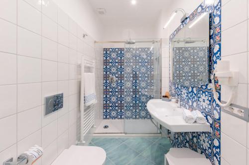 a white bathroom with a sink and a shower at Sea View Ravello in Ravello