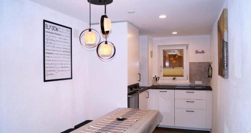 a kitchen with two pendant lights and a counter at Bergkristall Apartments in Ischgl