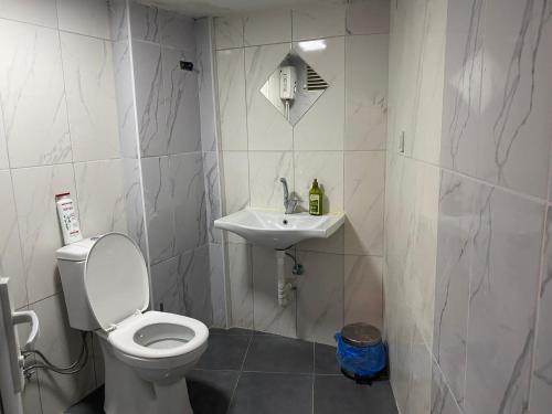 a bathroom with a toilet and a sink at Setpark Apart Otel in Bursa