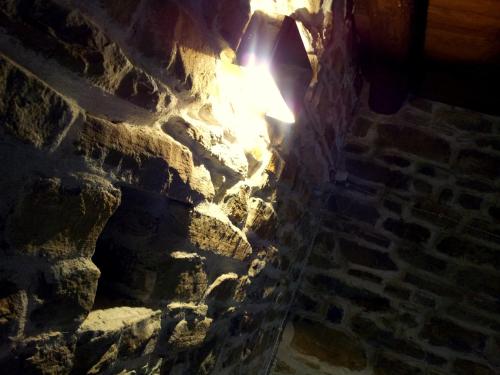 a stone wall with a light coming out of it at Navilla in Igliano