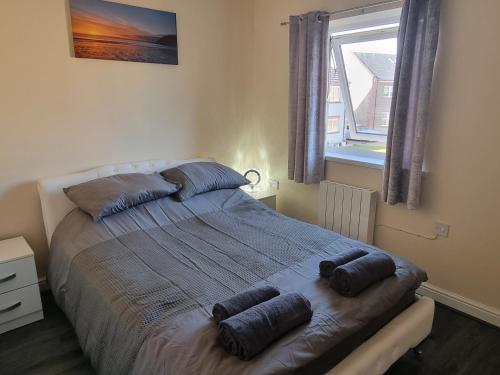 a bed in a bedroom with two pillows on it at Impeccable Beachfront 2-Bed Cottage in St Bees in St Bees